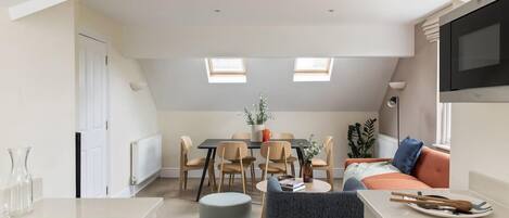 A modern apartment with a kitchen, dining area, and living space.