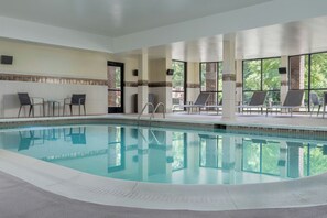 A swimming pool with lounge chairs and a view of trees. - Courtyard Largo Medical Center Drive (Upper Marlboro)