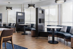 A modern lounge area with sofas, tables, and pendant lighting. - Courtyard Largo Medical Center Drive (Upper Marlboro)