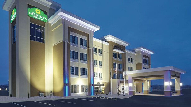 A multi-story hotel with a prominent sign for La Quinta Inn Suites.