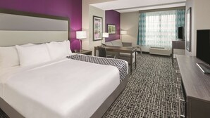 A hotel room with a large bed, a desk, and a TV. - La Quinta Inn & Suites by Wyndham Springfield IL (Springfield)