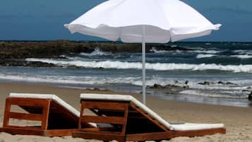 On the beach, sun-loungers, beach umbrellas, beach towels