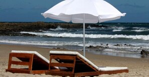 On the beach, sun-loungers, beach umbrellas, beach towels