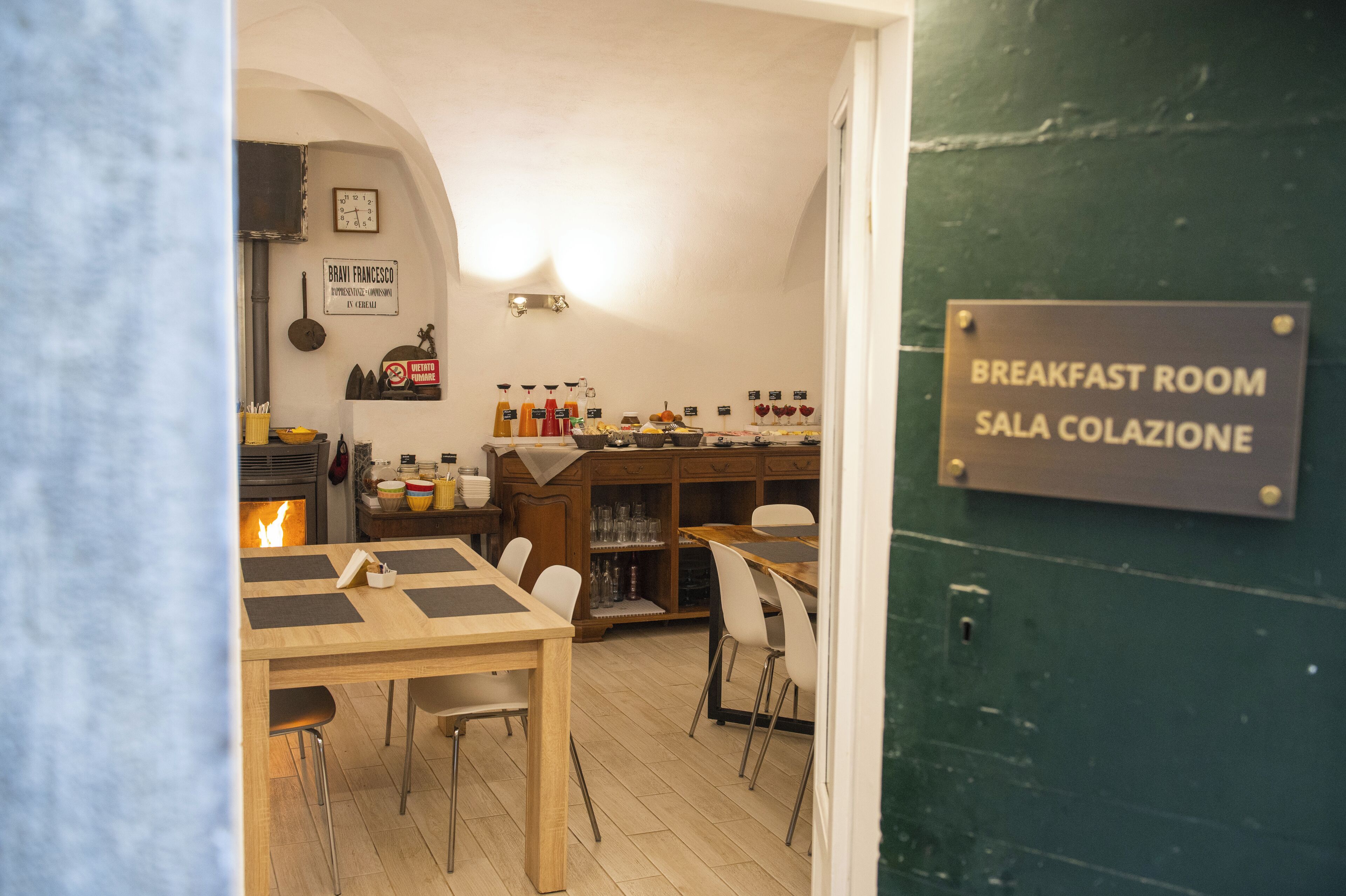 A breakfast room with a wooden table, chairs, and a sign indicating it's a breakfast area.