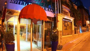 A hotel entrance with a glass door, a red awning, and a sign that reads "HOTEL BLANQUER". - Villa Blanche Hotel (Istanbul)