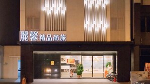 A hotel facade with vertical light patterns and a sign reading "LShotel". - Leesing Hotel (Kaohsiung)