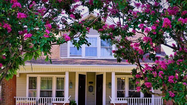 A two-story house with a front porch, a brick foundation, and a gabled roof. - 1895 Washington Hotel (Paducah)
