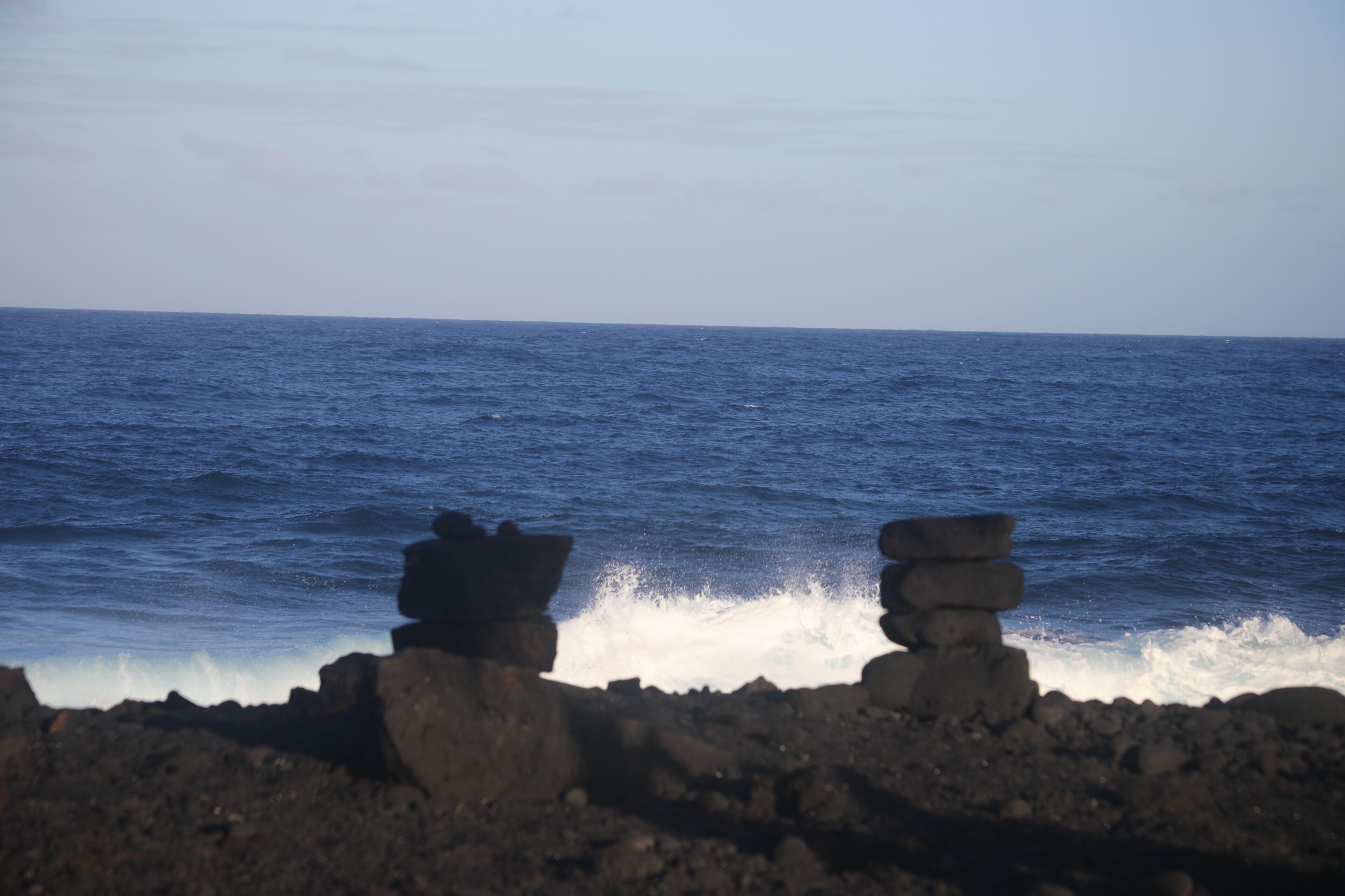A rocky shoreline with waves crashing against the rocks.