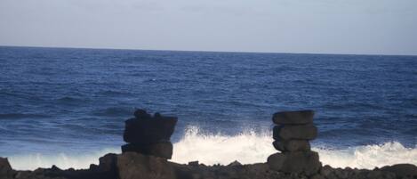 A rocky shoreline with waves crashing against the rocks.