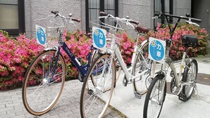 Three bicycles parked in front of a building with a sign that reads "Maite". - Hotel Morschein (Matsumoto)