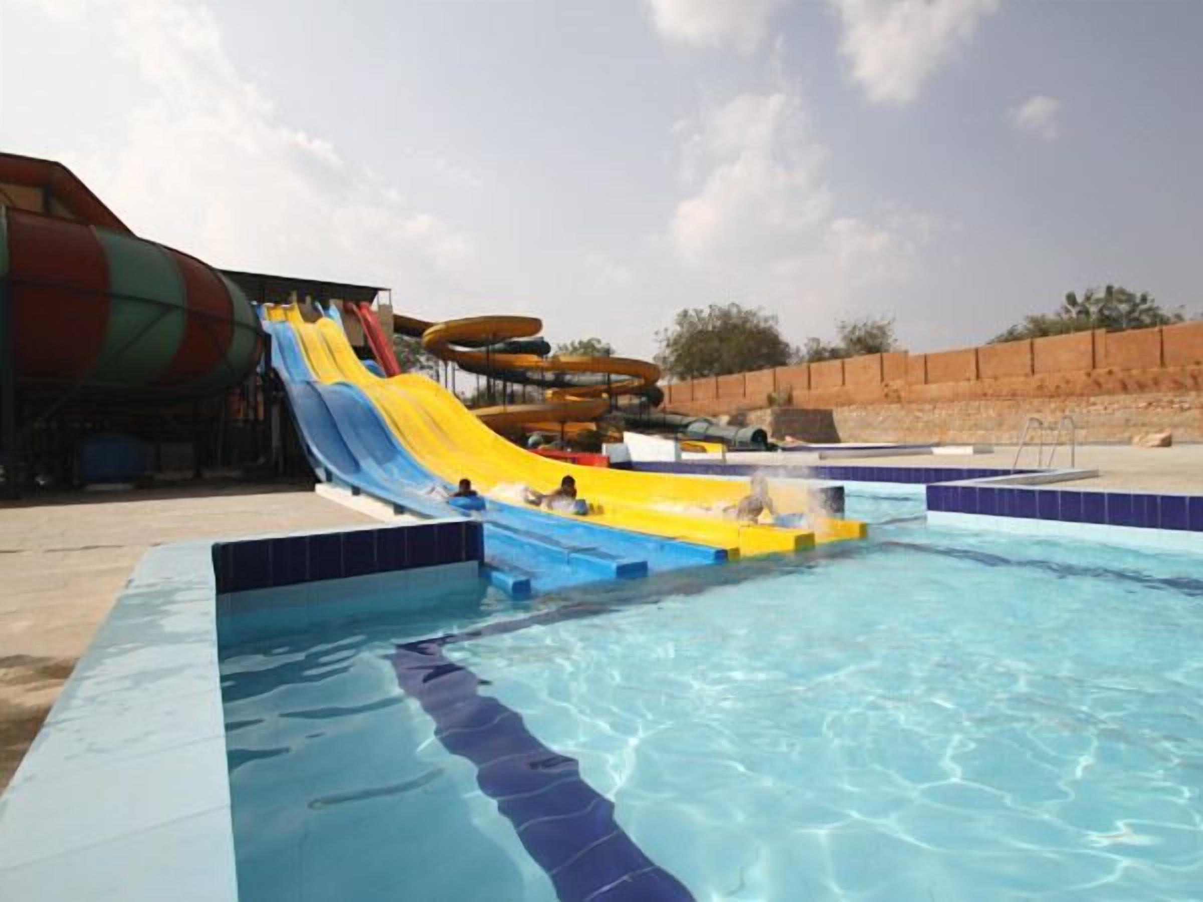 A water park with multiple water slides and a swimming pool.