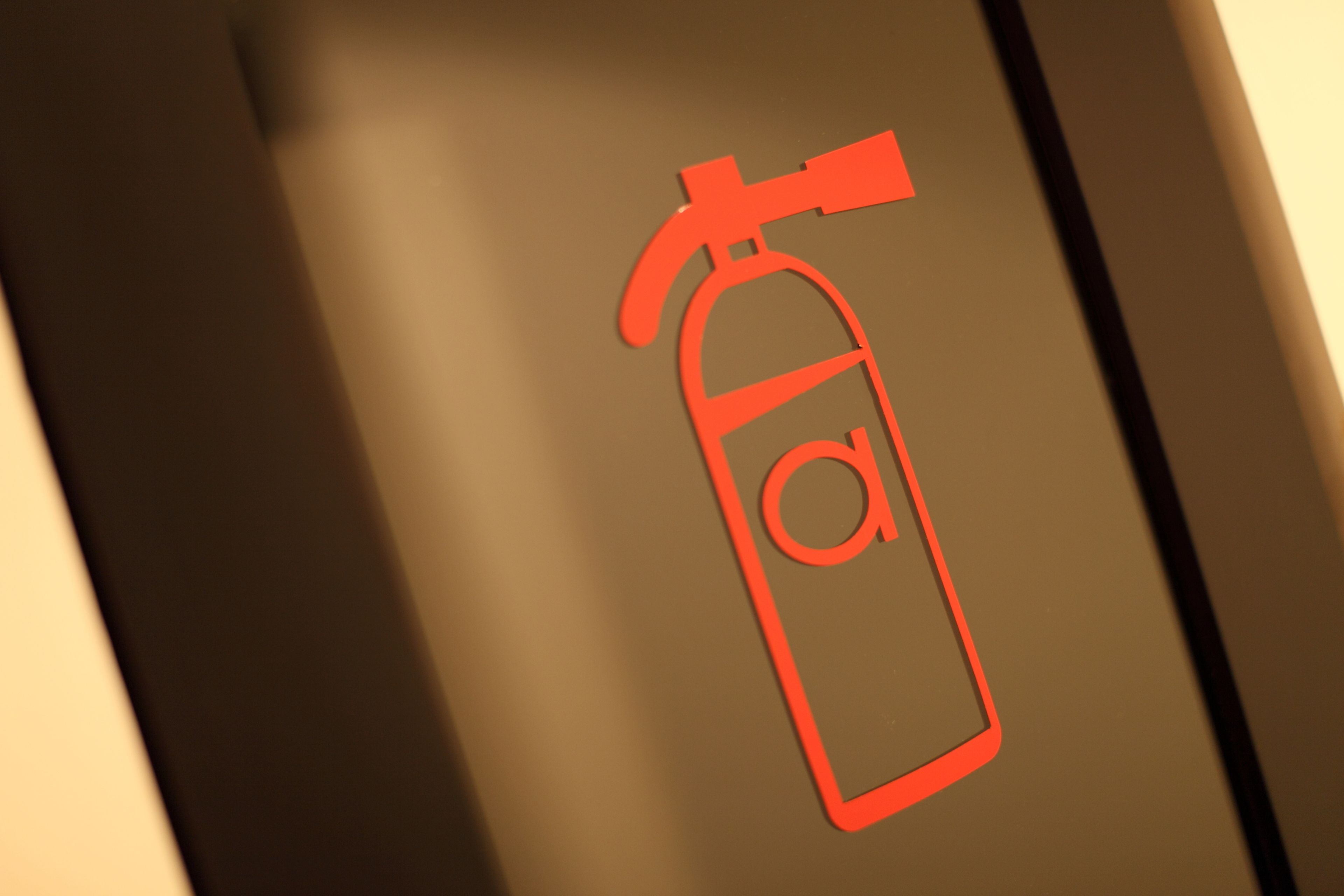 A fire extinguisher symbol on a wall.