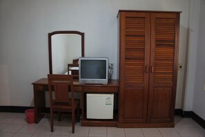 A room with a wooden desk, a television, a wardrobe, and a small refrigerator. - Sisavath Hotel (Vientiane)