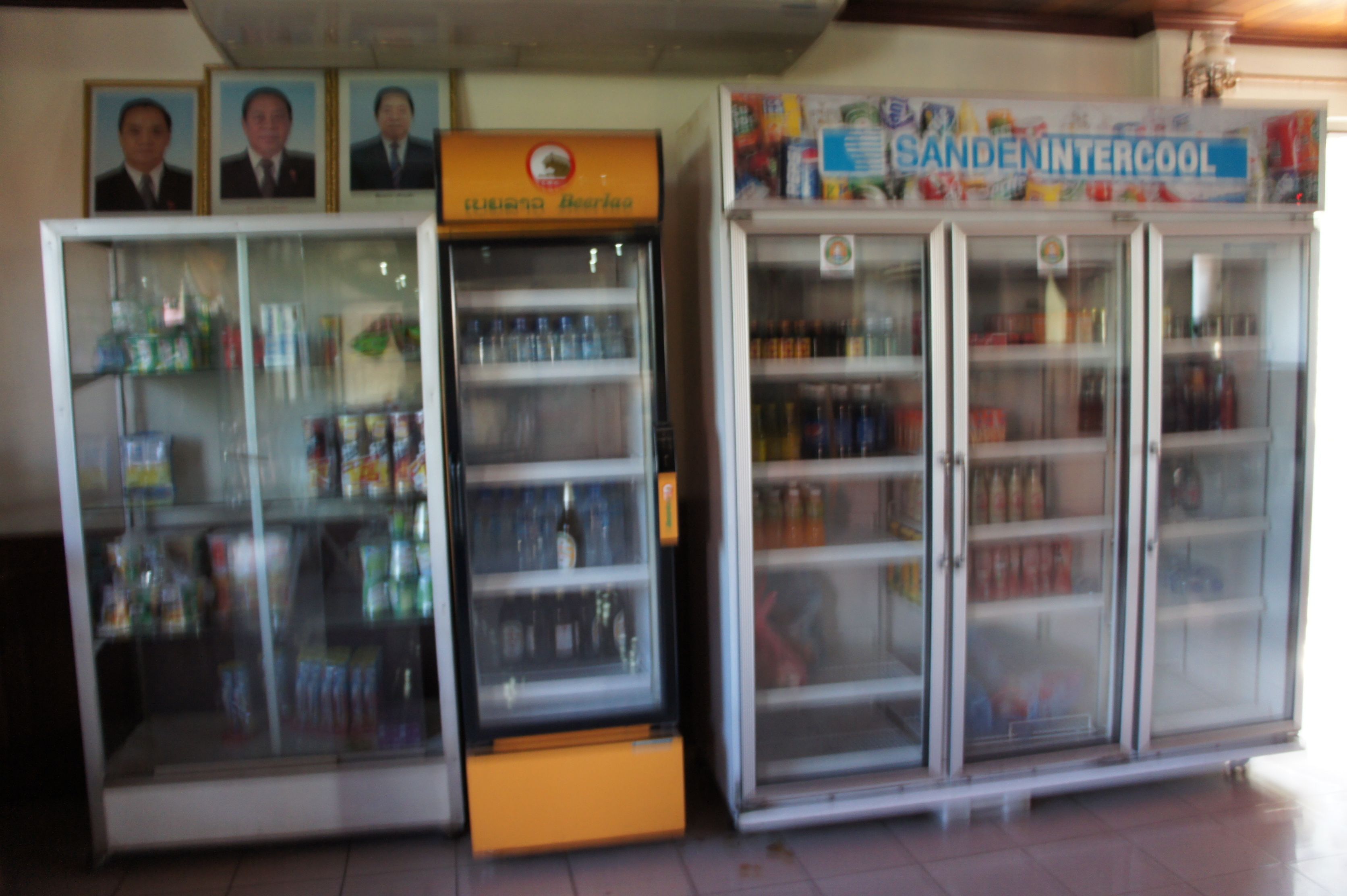 Three beverage dispensers in a commercial setting.