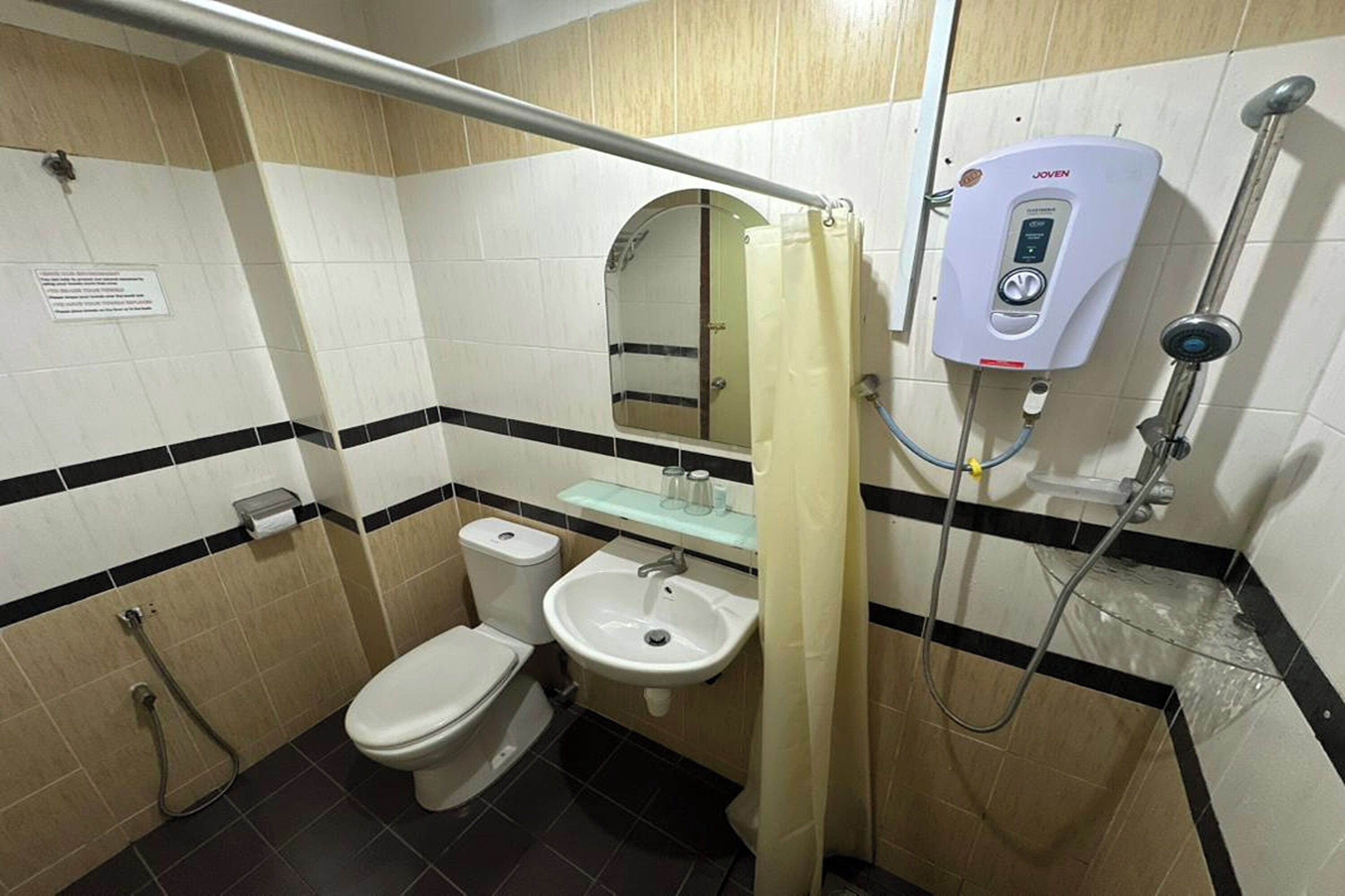 A bathroom with a toilet, sink, and shower.