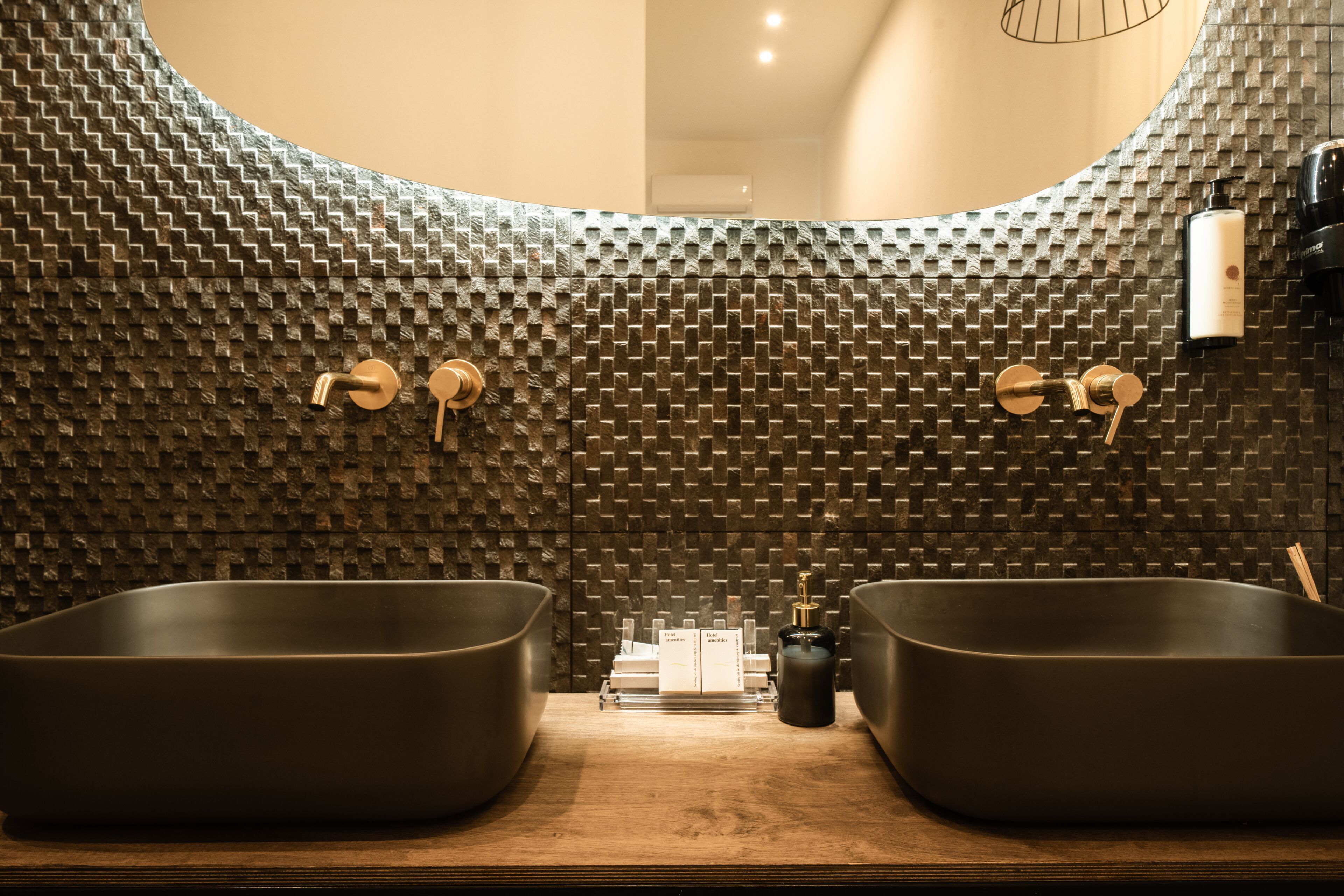 superior suite (infinity hot tub) | bathroom | free toiletries, hair dryer, slippers, towels