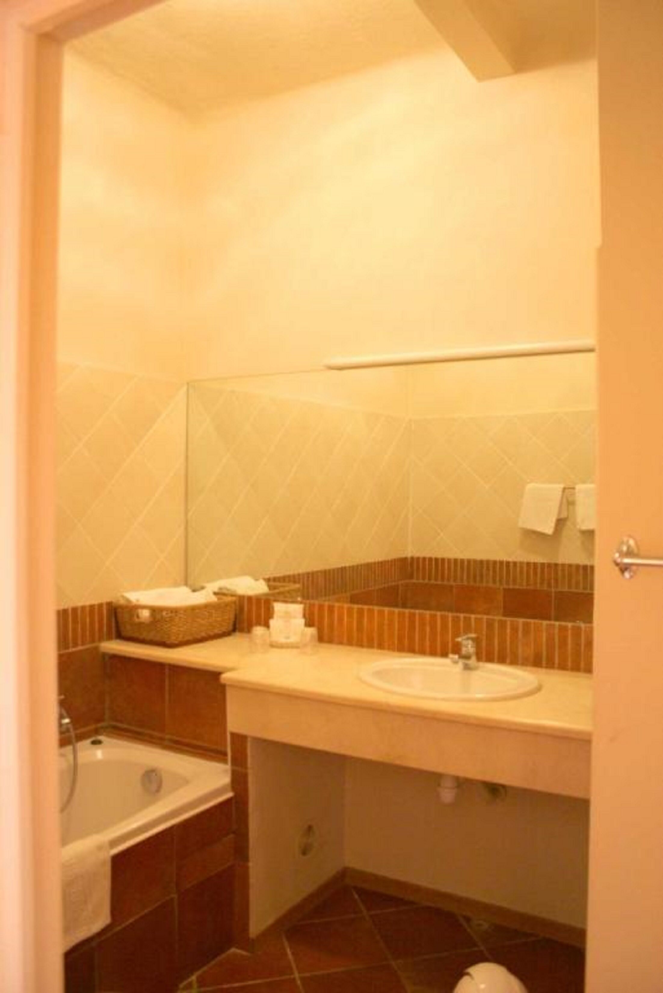 Un baño con bañera, lavabo y espejo.