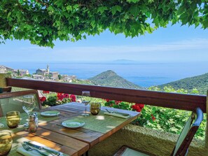 A table set for dining with a view of the sea and a distant mountain. - Hotel Restaurant La Corniche (San-Martino-di-Lota)