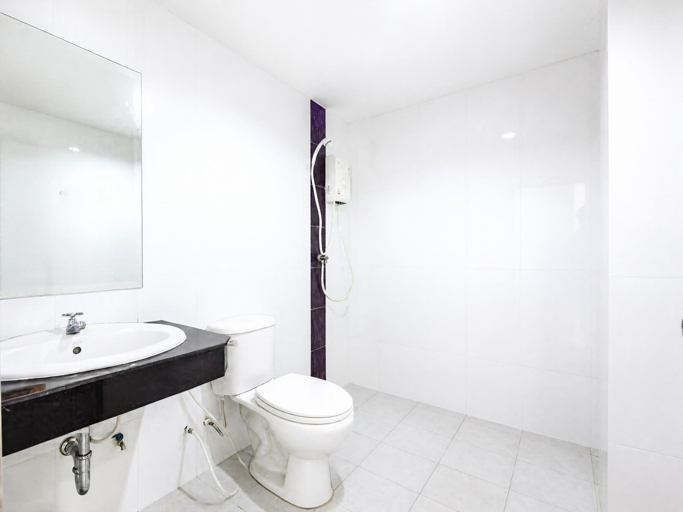 A modern bathroom with a white sink, toilet, and shower.