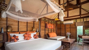 A wooden room with a large bed, a smaller bed, a desk, and a chair. - Serendipity Beach Resort Koh Lipe (Koh Lipe)