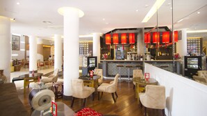 A hotel lobby with a bar area, seating arrangements, and a decorative ceiling. - Chinatown Hostel (Bangkok)