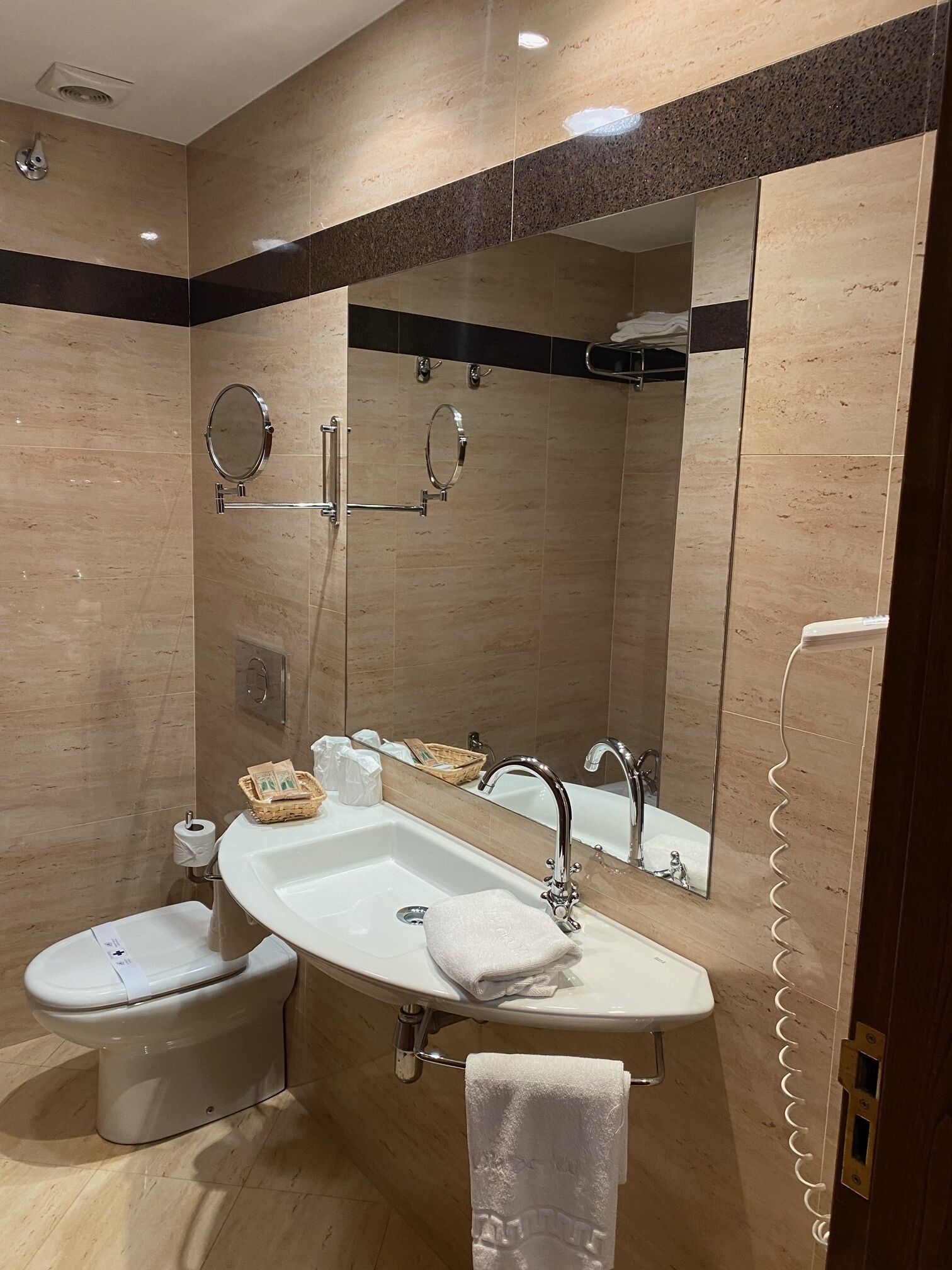 A modern bathroom with a vanity, sink, and toilet.
