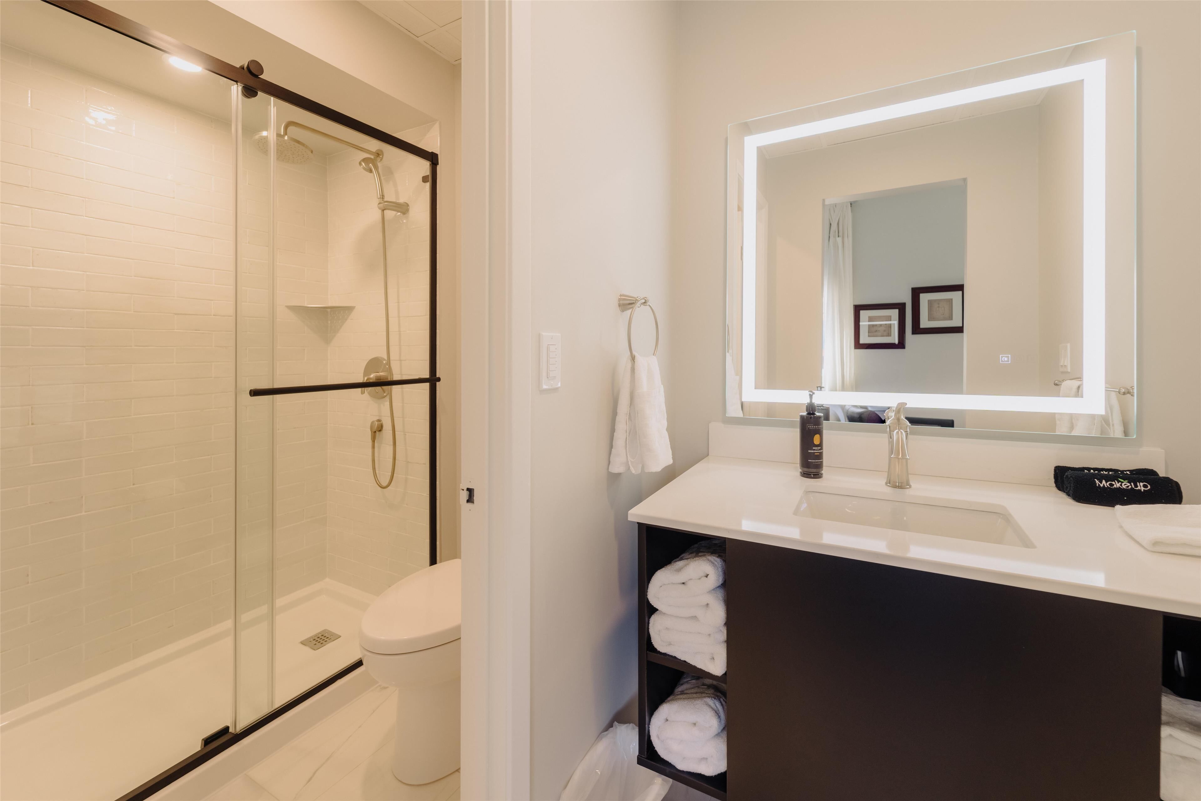 designer toiletries, hair dryer, towels, soap