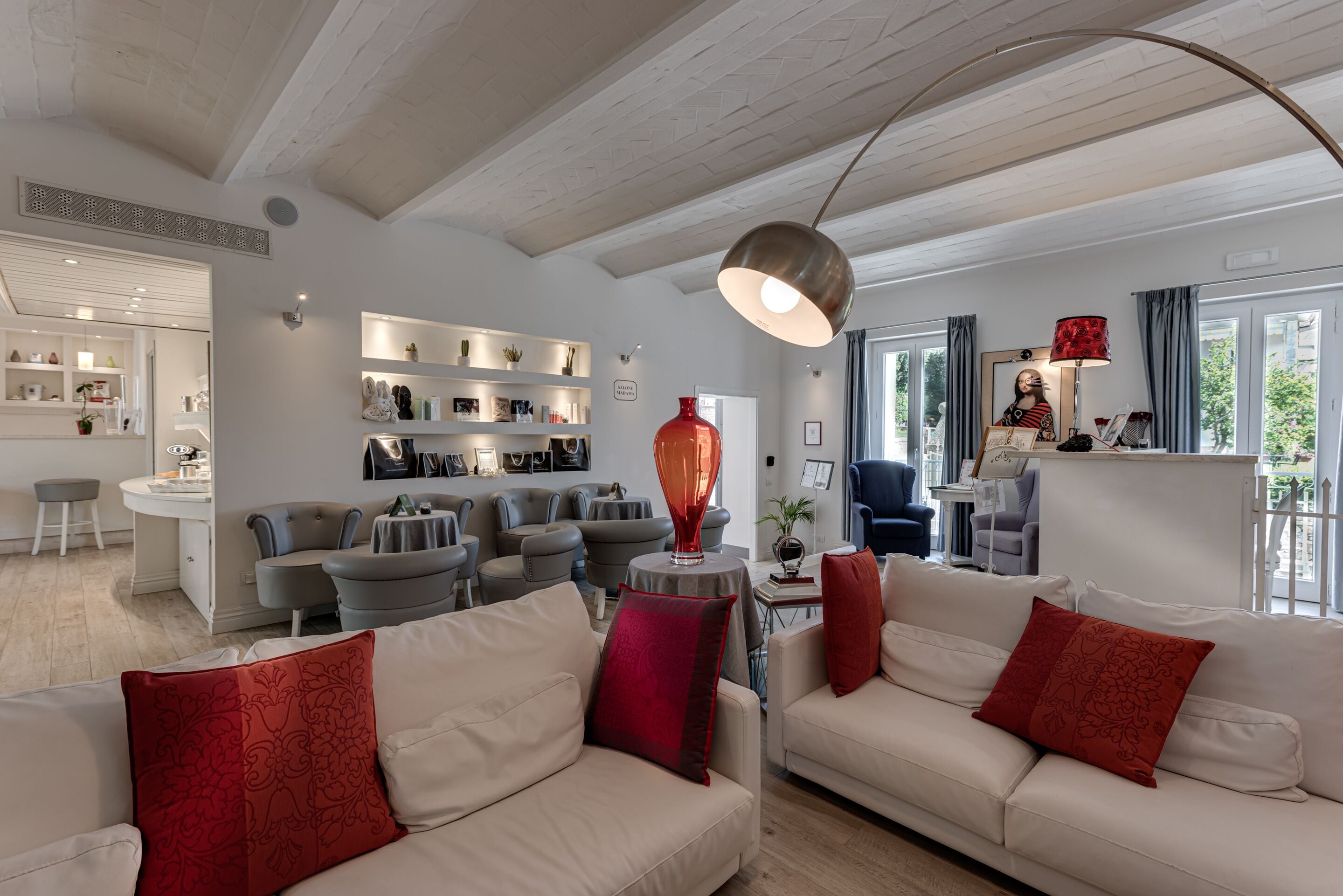 A modern living room with a high ceiling, a dining area, and a kitchen.