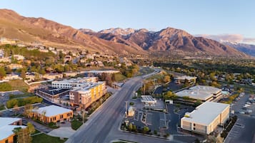 A town with a main road, buildings, and mountains in the background.