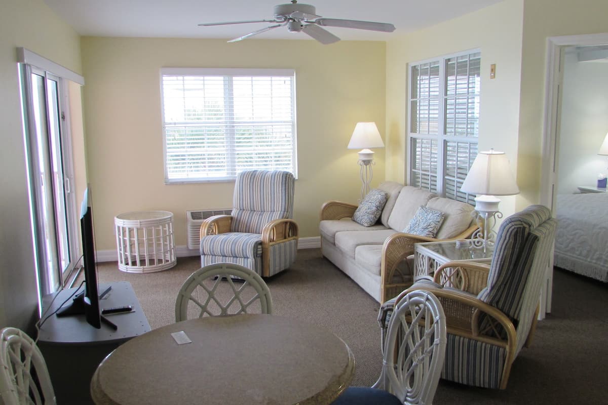 Apartment, 1 King Bed, Partial Ocean View | In-room safe, desk, laptop workspace, iron/ironing board