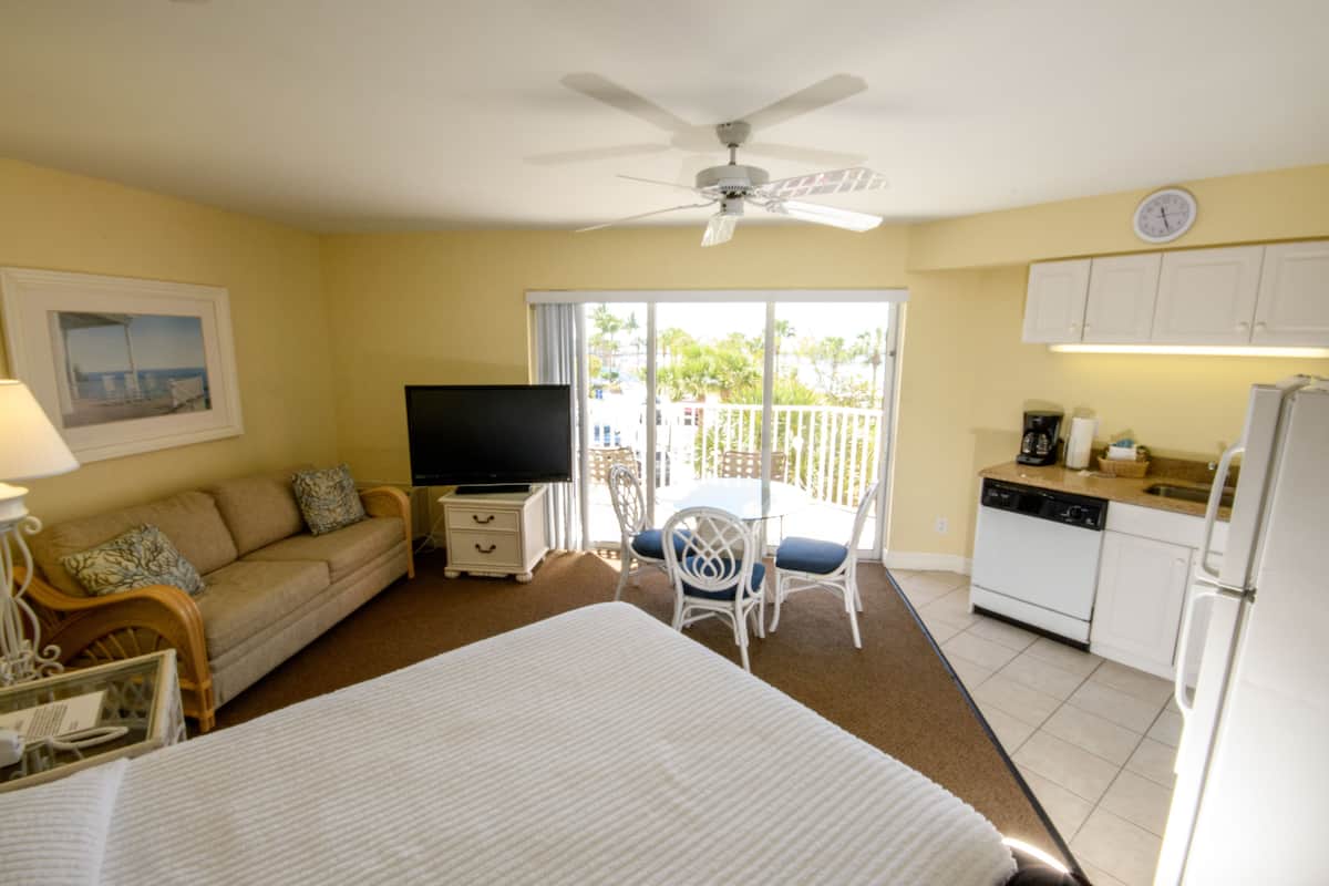 Studio, 1 Queen Bed, Partial Ocean View | In-room safe, desk, laptop workspace, iron/ironing board