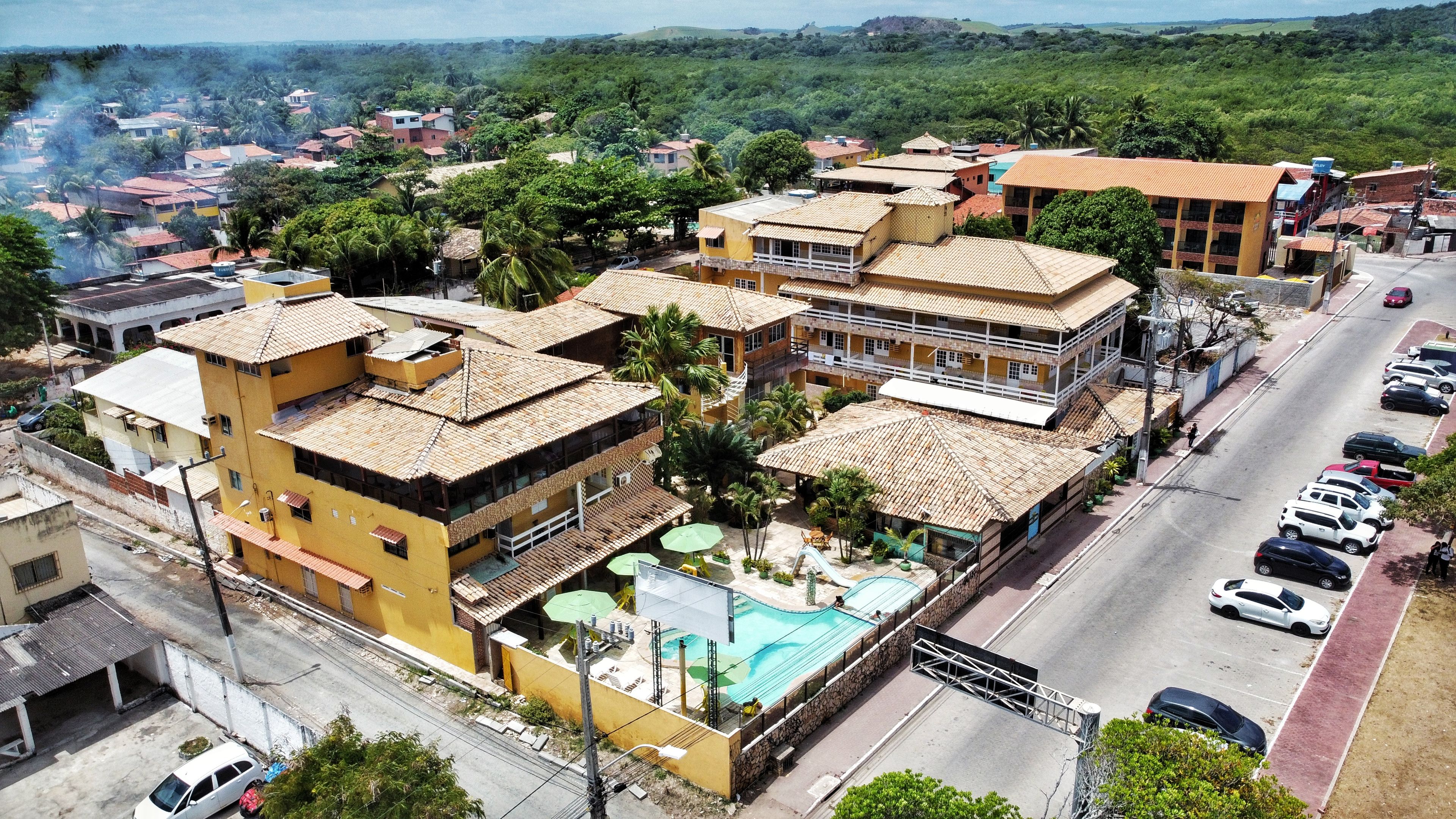 A residential area with multiple buildings, a swimming pool, and a parking lot.