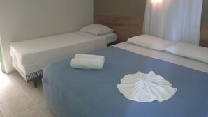 A hotel room with a bed, a small bedside table, and a window with curtains. - Pousada Boi Bumbá Praia (João Pessoa)