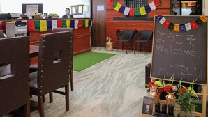 A hotel reception area with a check-in counter, a reception desk, and a welcome sign. - Apartment Hotel 11 Thamel (Kathmandu)