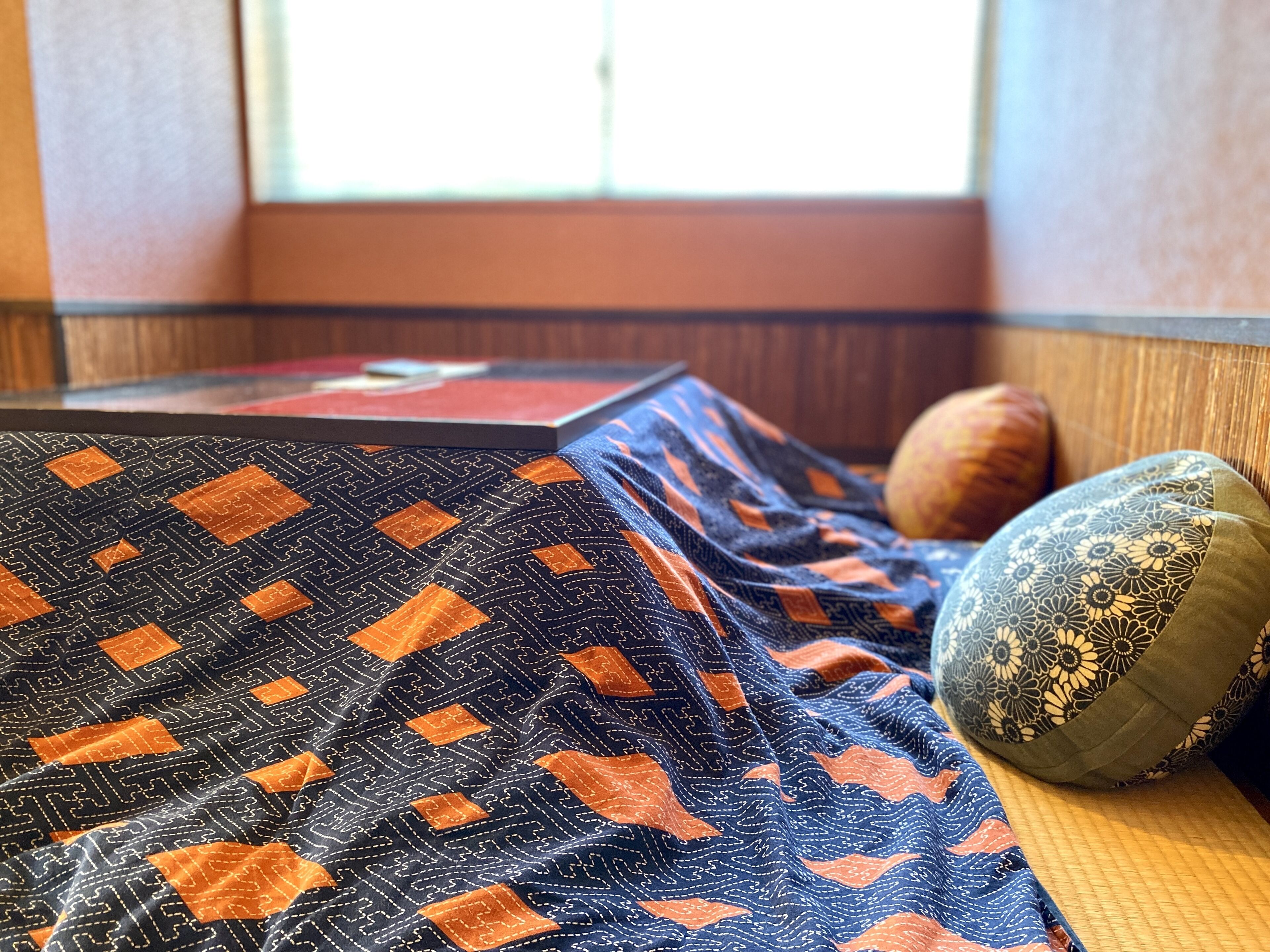 A room with a bed, a pillow, and a window.
