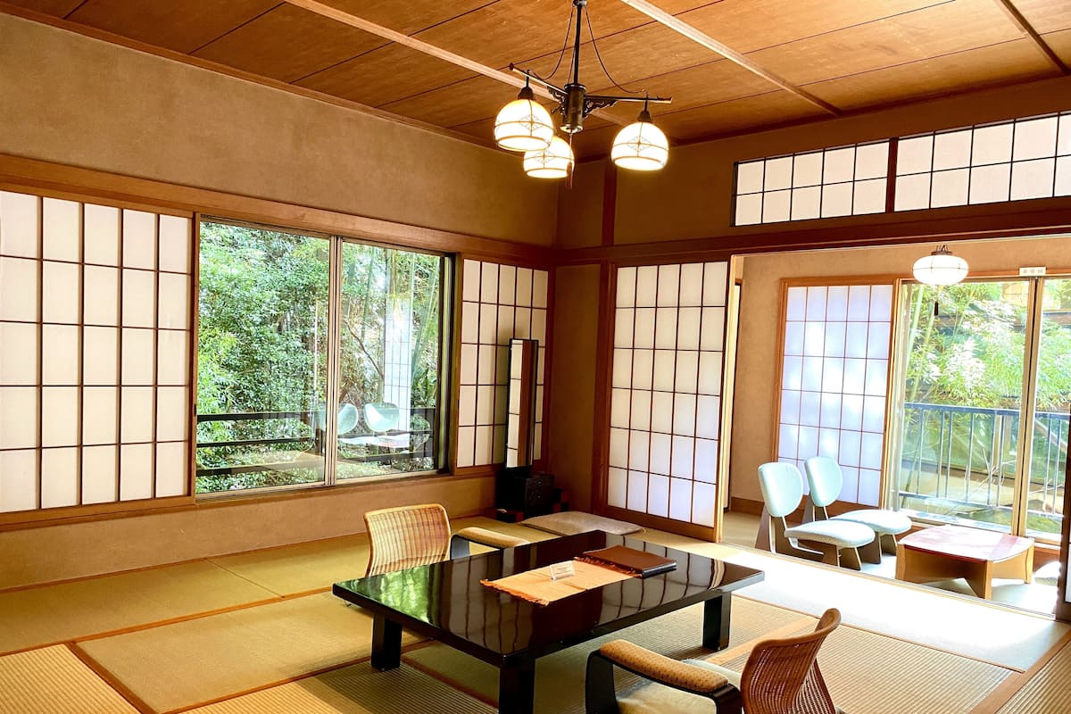 A traditional Japanese room with tatami flooring, a low table, and shoji screens.