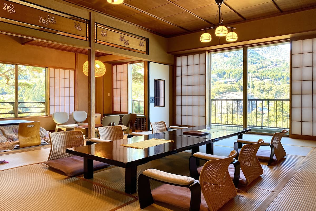 A traditional Japanese-style room with tatami flooring, a low table, and shoji screens.