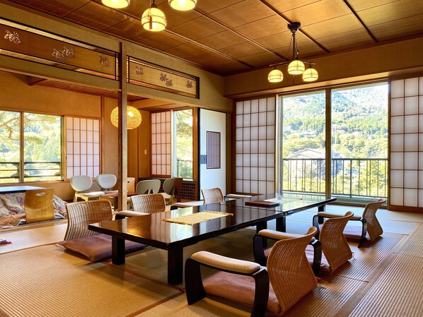 A traditional Japanese-style room with tatami flooring, a low table, and shoji screens.