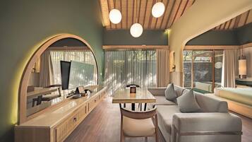 A modern interior with a dining area, sofa, and a large mirror.