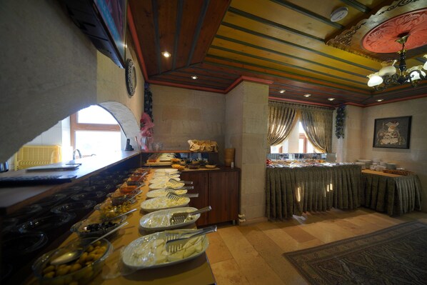 A buffet setup with various food items and utensils.