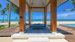 A beachside cabana with a swing bed overlooking the ocean. - Sirarun Resort (Thap Sakae)