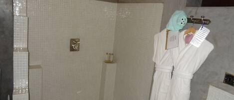 A bathroom with a shower, a bathtub, and a toilet.