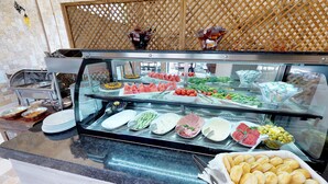 A buffet with various food items including fruits, vegetables, and bread. - Patron Hotel (Antalya)