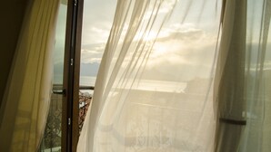 A room with a view of a cityscape through sheer curtains. - Patron Hotel (Antalya)