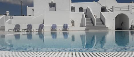 Outdoor pool, open 11:30 AM to 5 PM, pool umbrellas, pool loungers