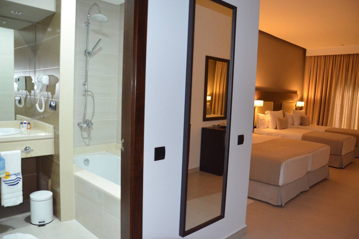 family room | premium bedding, minibar, in-room safe, desk