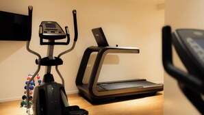A home gym with a stationary bike and a treadmill. - 9Hotel Republique (Paris)