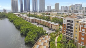 A high-rise residential area with multiple apartment buildings, a river, and a marina. - Sunny Isles Apartments by MiaRentals (Sunny Isles Beach)