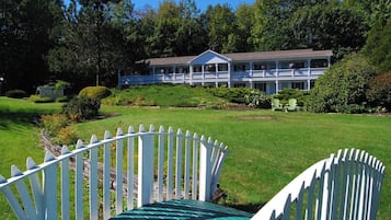 Relax on the porch amidst lush greenery and well-maintained lawns.