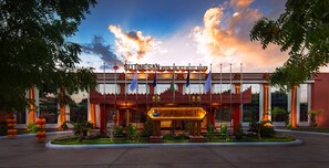 A hotel entrance with a sign reading "SUTINESAN ROYAL HOTEL BANGKOK".
